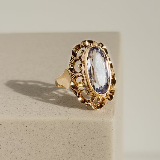 Elegant 14 karat gold ring with light blue gemstone