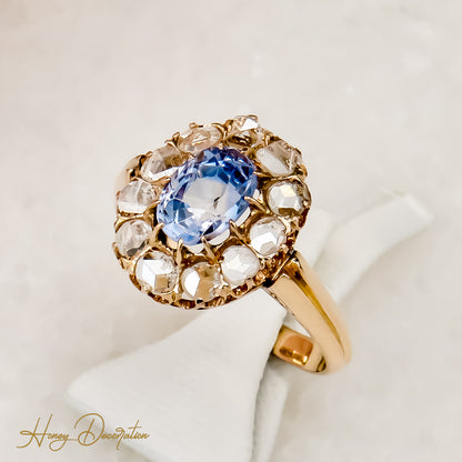 Golden ring with diamond roses and mystical sapphire