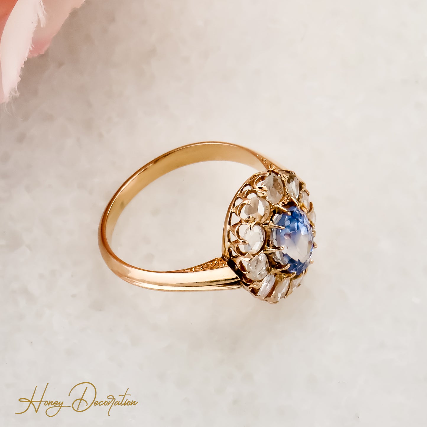 Golden ring with diamond roses and mystical sapphire